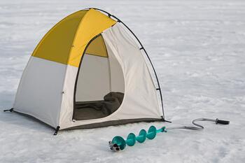 Angler sitting on a box during a short break on the ice
