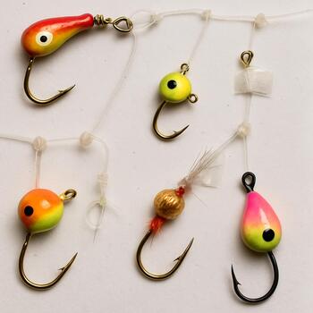 Pre-tied ice fishing rigs stored on a foam board with labels