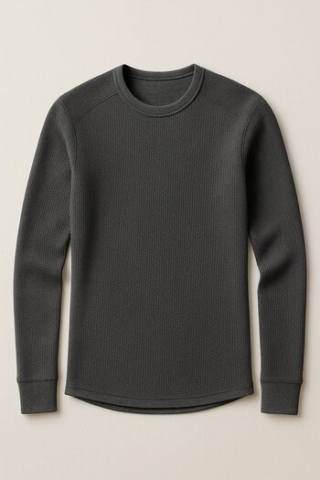 Thermal base layer top and leggings folded on a bench