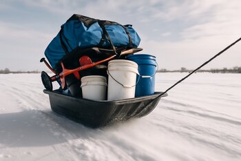 Large ice fishing sled fully loaded with shelter and gear